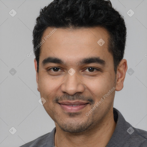 Joyful latino young-adult male with short  black hair and brown eyes