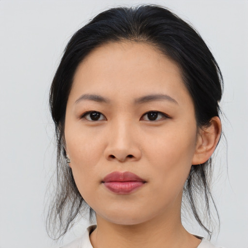 Joyful asian young-adult female with medium  black hair and brown eyes