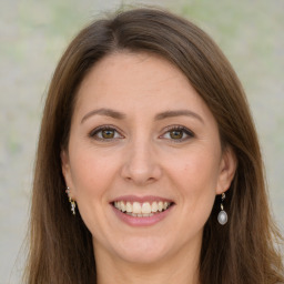 Joyful white young-adult female with long  brown hair and green eyes