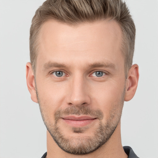 Joyful white adult male with short  brown hair and grey eyes