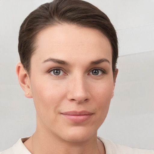 Joyful white young-adult female with short  brown hair and brown eyes