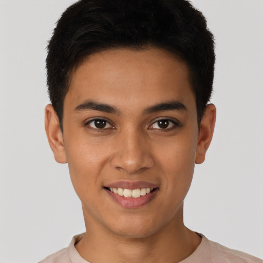 Joyful latino young-adult male with short  black hair and brown eyes