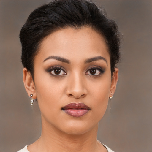 Joyful latino young-adult female with short  brown hair and brown eyes