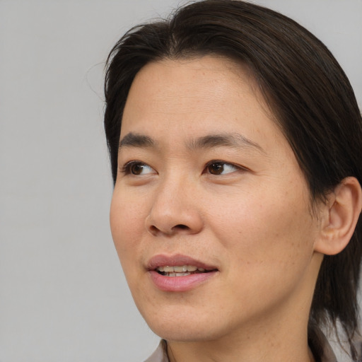 Joyful asian adult female with short  brown hair and brown eyes