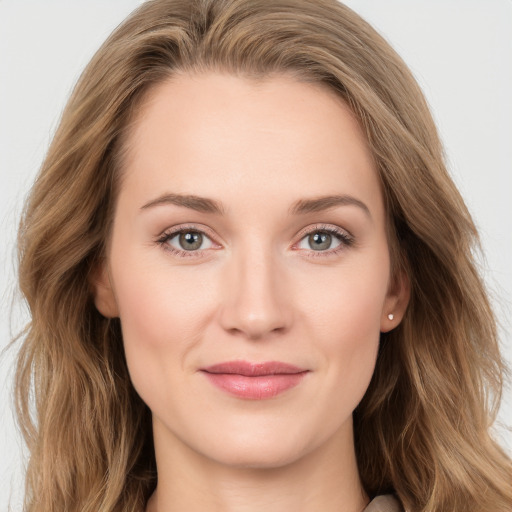 Joyful white young-adult female with long  brown hair and blue eyes