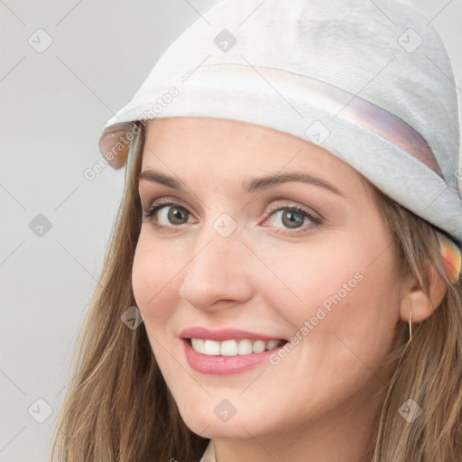 Joyful white young-adult female with long  brown hair and blue eyes