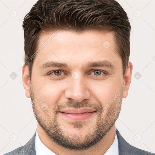 Joyful white young-adult male with short  brown hair and grey eyes