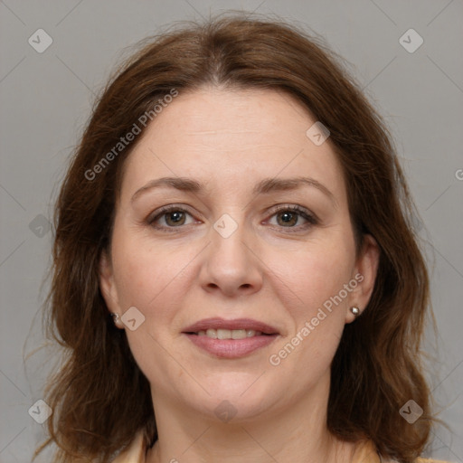 Joyful white adult female with long  brown hair and brown eyes