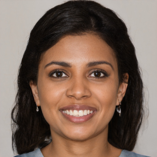 Joyful black young-adult female with medium  brown hair and brown eyes