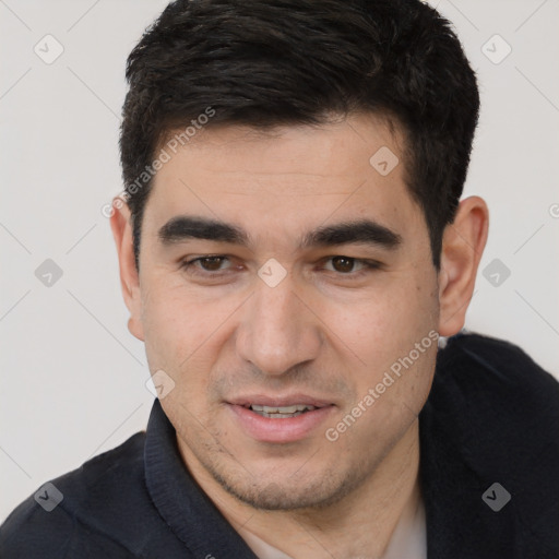 Joyful white young-adult male with short  black hair and brown eyes