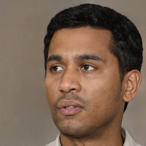 Neutral black young-adult male with short  black hair and brown eyes