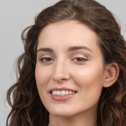 Joyful white young-adult female with long  brown hair and blue eyes