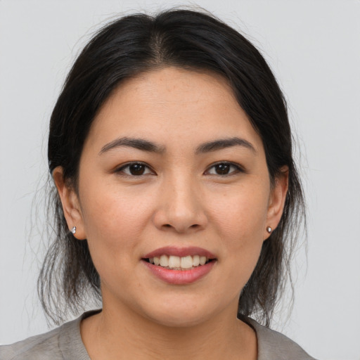 Joyful asian young-adult female with medium  brown hair and brown eyes