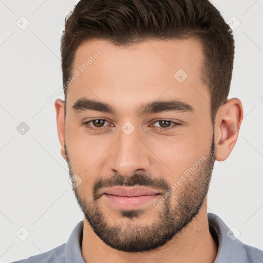 Joyful white young-adult male with short  brown hair and brown eyes