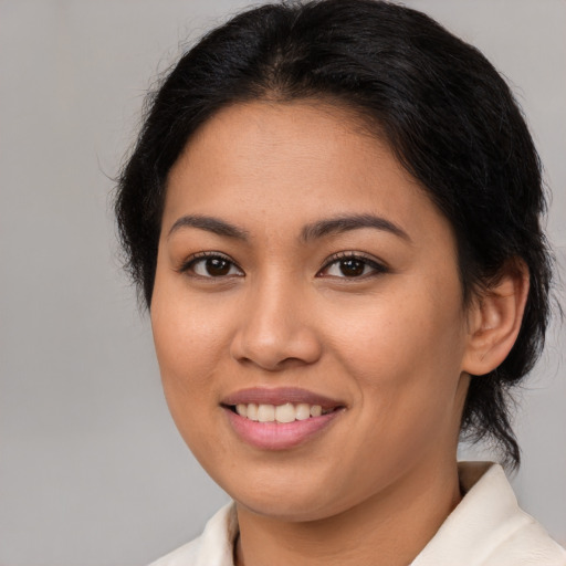 Joyful asian young-adult female with medium  brown hair and brown eyes