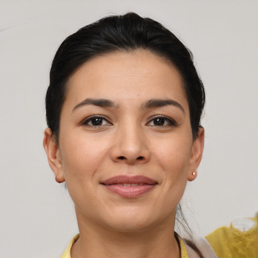 Joyful latino young-adult female with short  brown hair and brown eyes