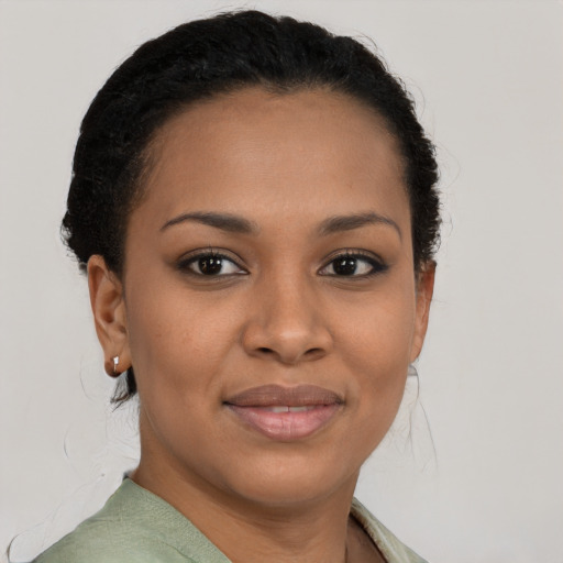Joyful black young-adult female with short  brown hair and brown eyes