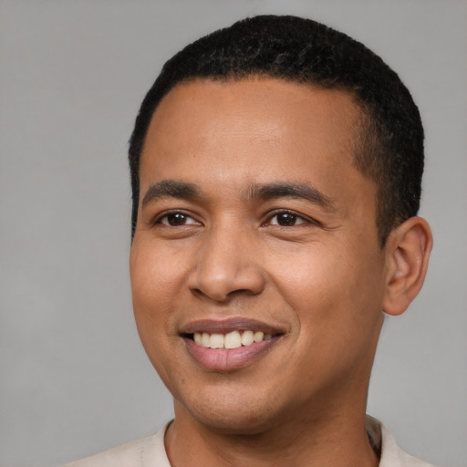 Joyful latino young-adult male with short  brown hair and brown eyes