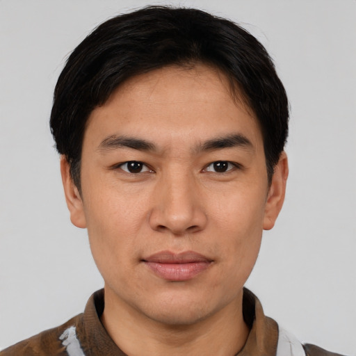 Joyful asian young-adult male with short  brown hair and brown eyes