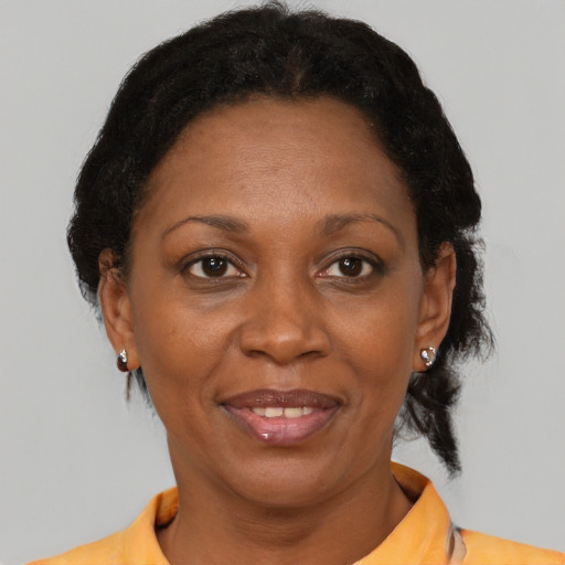Joyful black adult female with short  brown hair and brown eyes