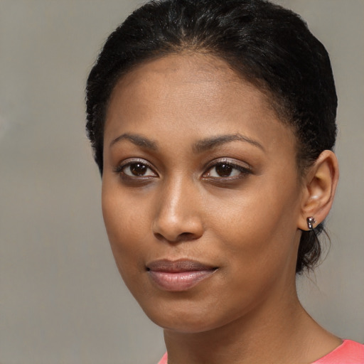 Joyful black young-adult female with medium  brown hair and brown eyes