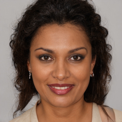 Joyful black young-adult female with medium  brown hair and brown eyes