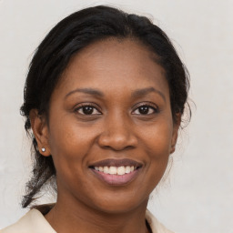 Joyful black adult female with medium  brown hair and brown eyes