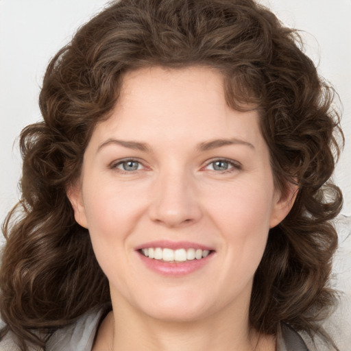 Joyful white young-adult female with medium  brown hair and green eyes