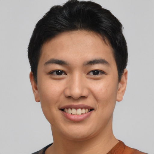 Joyful asian young-adult male with short  brown hair and brown eyes