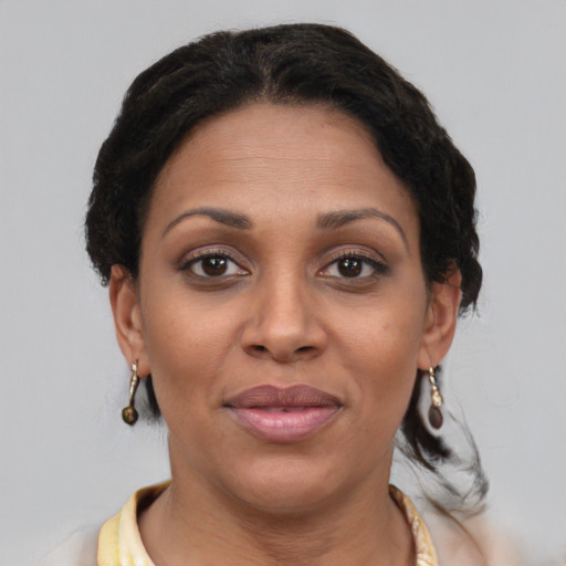 Joyful black young-adult female with short  brown hair and brown eyes