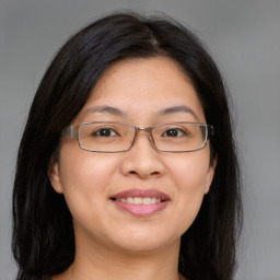 Joyful white adult female with long  brown hair and brown eyes