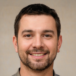 Joyful white young-adult male with short  brown hair and brown eyes