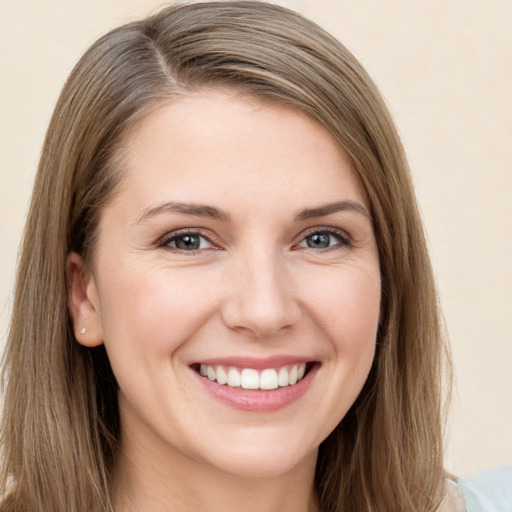 Joyful white young-adult female with long  brown hair and grey eyes