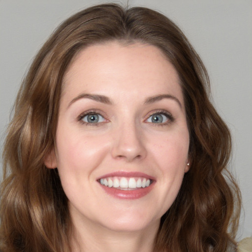 Joyful white young-adult female with long  brown hair and green eyes