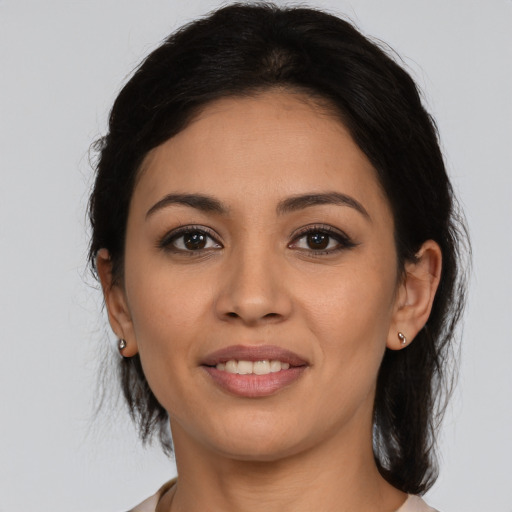 Joyful latino young-adult female with medium  brown hair and brown eyes