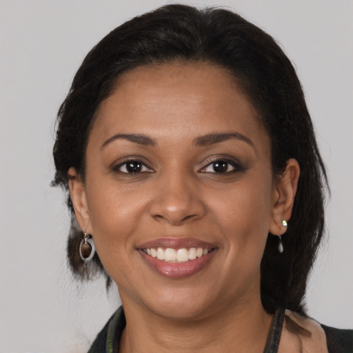 Joyful black young-adult female with medium  brown hair and brown eyes