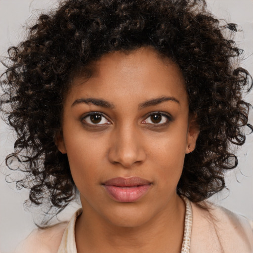 Neutral black young-adult female with medium  brown hair and brown eyes