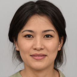 Joyful asian young-adult female with medium  brown hair and brown eyes