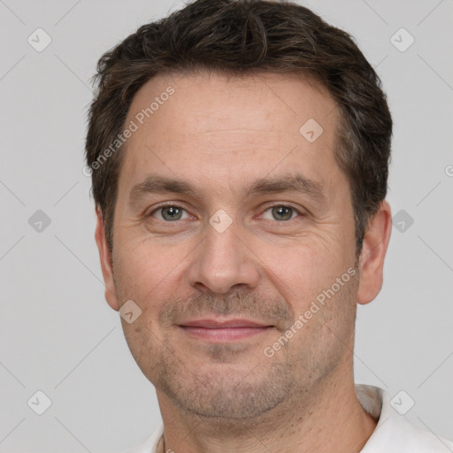 Joyful white adult male with short  brown hair and brown eyes