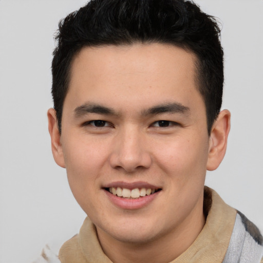 Joyful asian young-adult male with short  brown hair and brown eyes