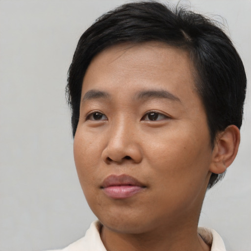 Joyful asian adult female with short  black hair and brown eyes