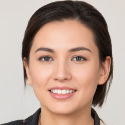 Joyful white young-adult female with medium  brown hair and brown eyes