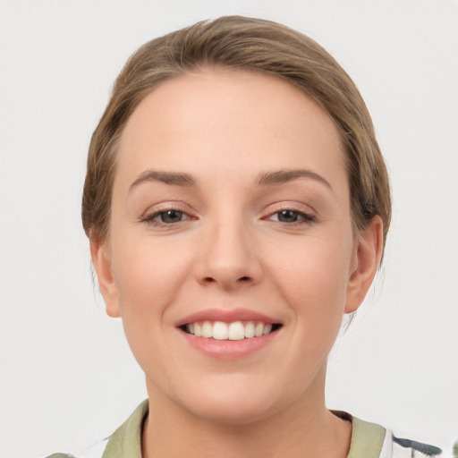 Joyful white young-adult female with medium  brown hair and grey eyes