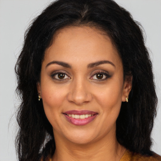 Joyful latino young-adult female with long  brown hair and brown eyes