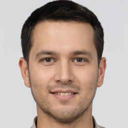 Joyful white young-adult male with short  brown hair and brown eyes