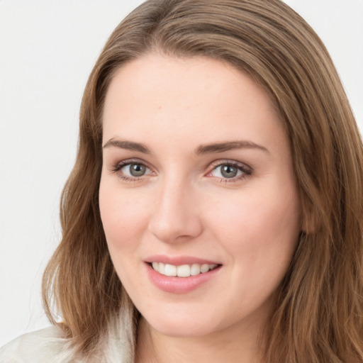 Joyful white young-adult female with long  brown hair and green eyes