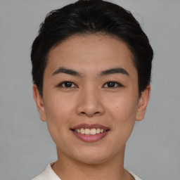 Joyful asian young-adult female with short  black hair and brown eyes