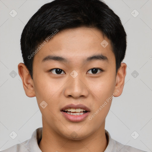 Joyful asian young-adult male with short  brown hair and brown eyes