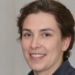 Joyful white adult female with medium  brown hair and brown eyes