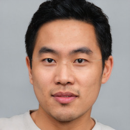 Joyful asian young-adult male with short  black hair and brown eyes